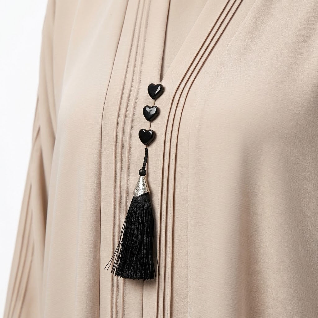 Close-up detail of Champagne Beige Pintuck Panel Gown showcasing vertical panel pintucks and heart studs