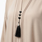 Close-up detail of Champagne Beige Pintuck Panel Gown showcasing vertical panel pintucks and heart studs