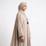 Full length styled look of Champagne Beige Pintuck Panel Gown with waist tie belt