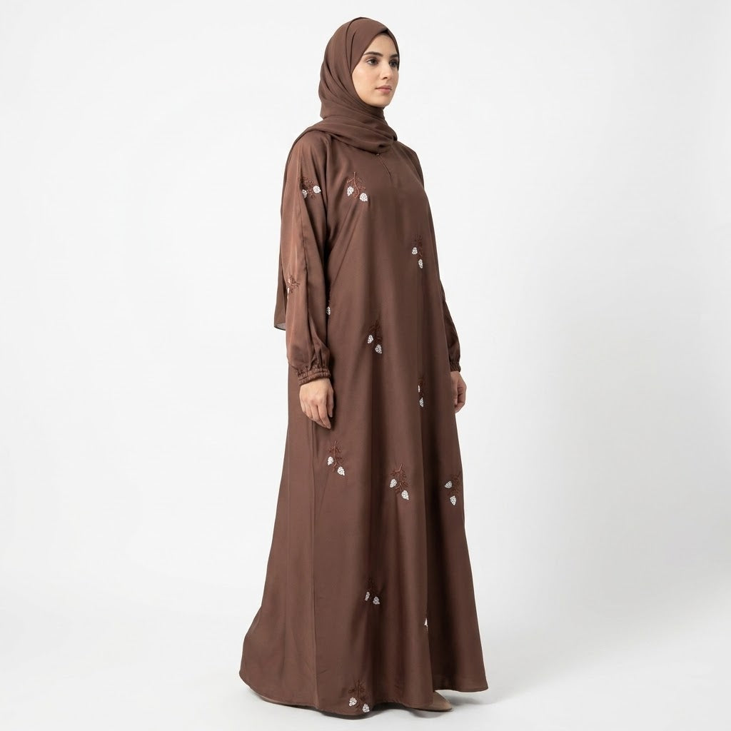 Off-white floral sprig embroidery detail on chocolate brown abaya