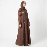Off-white floral sprig embroidery detail on chocolate brown abaya