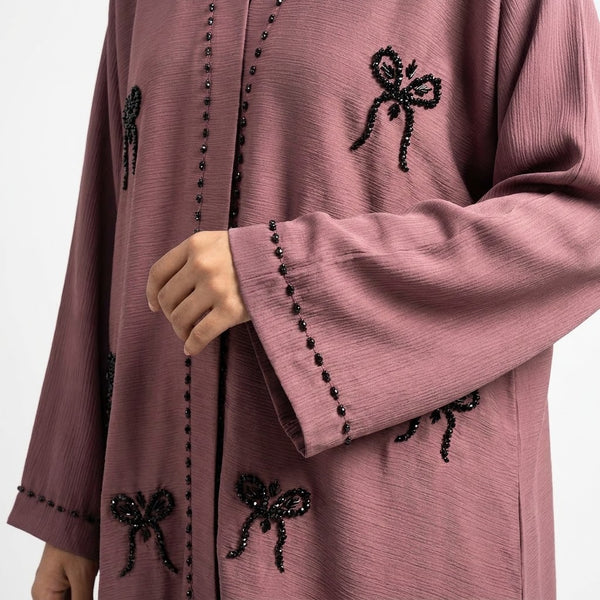 Styled look of Mauve Ribbon Abaya, perfect for * formal gatherings, festive occasions, evening wear, or chic everyday modest fashion. * *care instructions:* dry clean or gentle hand wash in cold water only; hang to dry to protect hand-beaded details