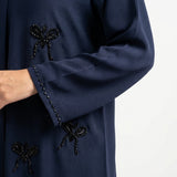 Close-up detail of Hand-Crafted Cut-Dana Bow Abaya showcasing the design work