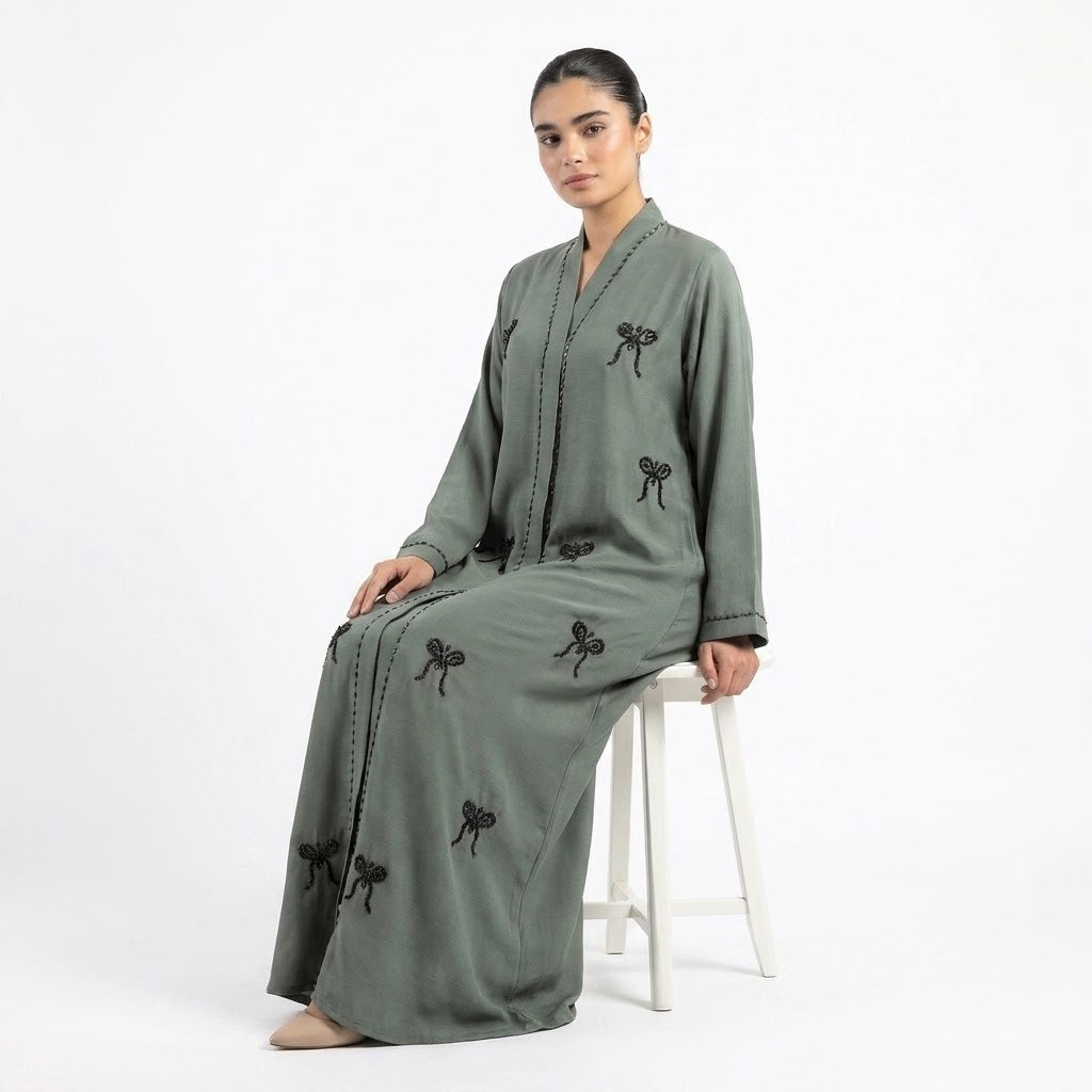 Styled look of Hand-Crafted Cut-Dana Bow Coat, perfect for semi-formal gatherings, festive celebrations, boutique events, and luxury modest wear