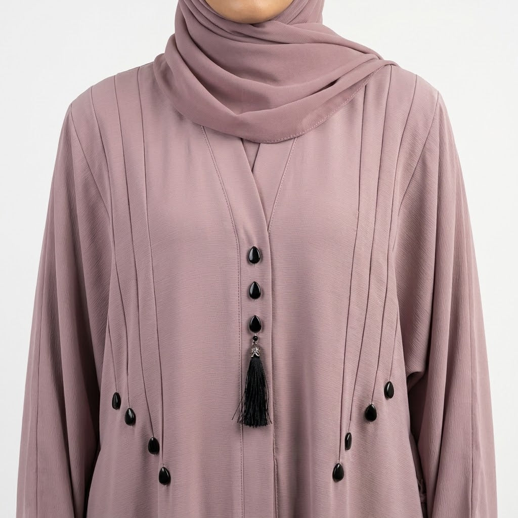 Pintucks and teardrop stud detail on dusty pink abaya