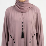 Pintucks and teardrop stud detail on dusty pink abaya