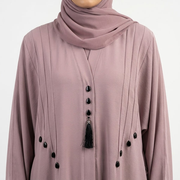 Pintucks and teardrop stud detail on dusty pink abaya