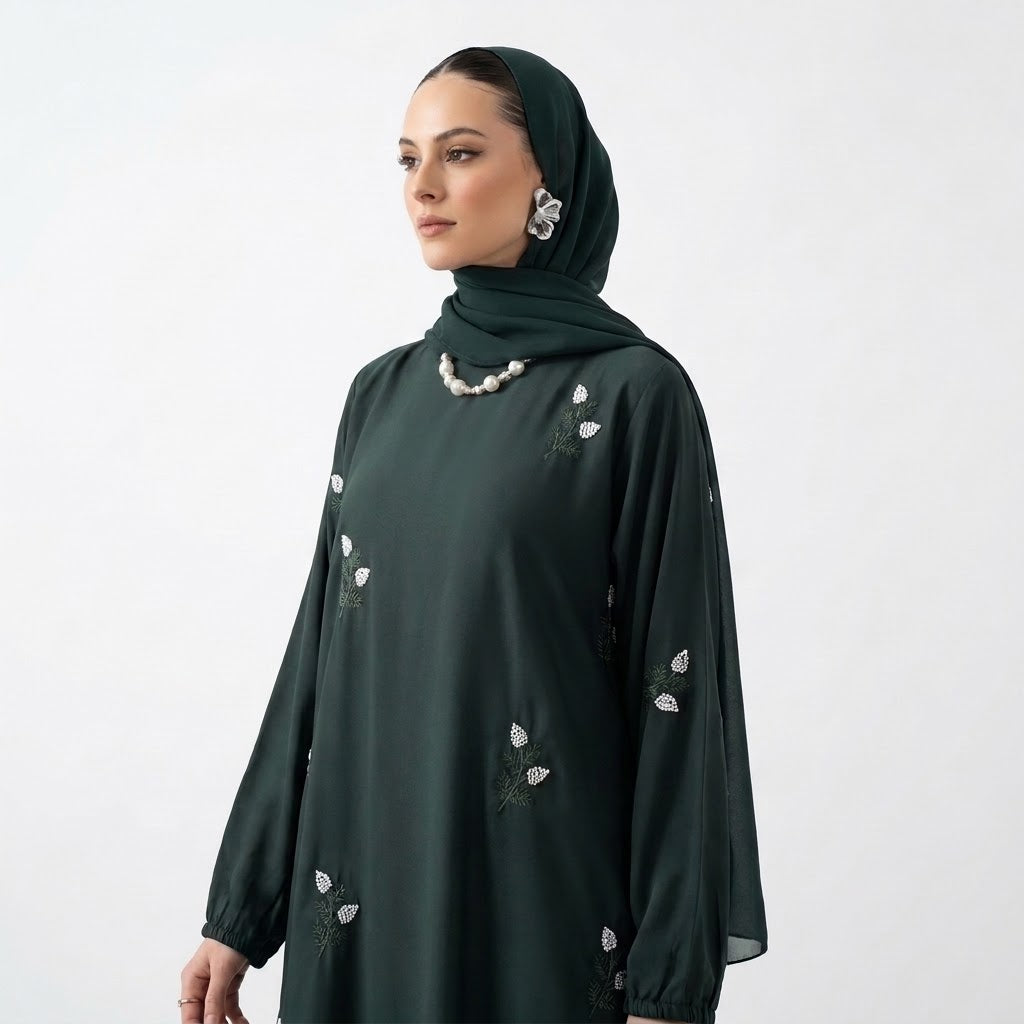 White floral sprig embroidery with sage stems on emerald abaya