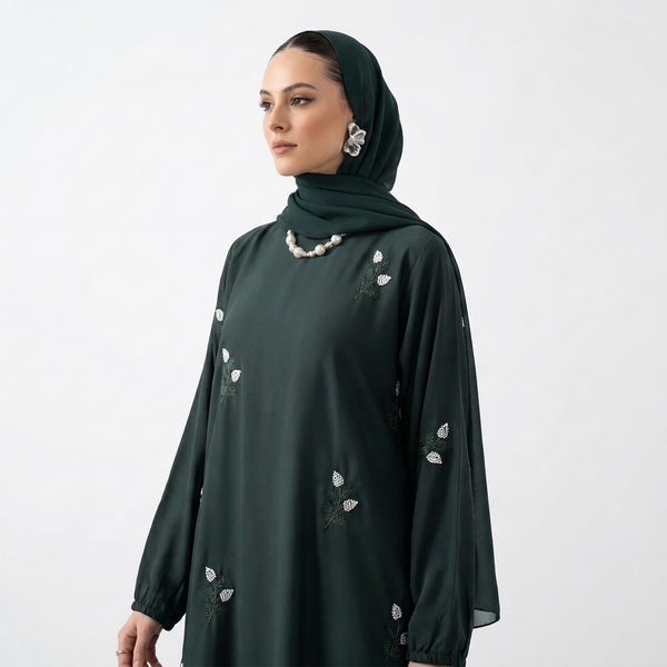 White floral sprig embroidery with sage stems on emerald abaya