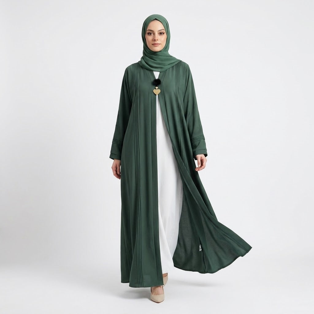 Close-up detail of Emerald Pin-Tuck 2-in-1 Abaya showcasing pin-tuck pleats and heart charm