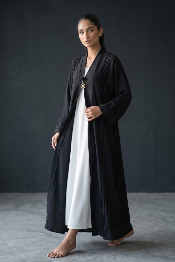 Front view of Monochrome Pleated Brooch Abaya - black and white pre-layered abaya