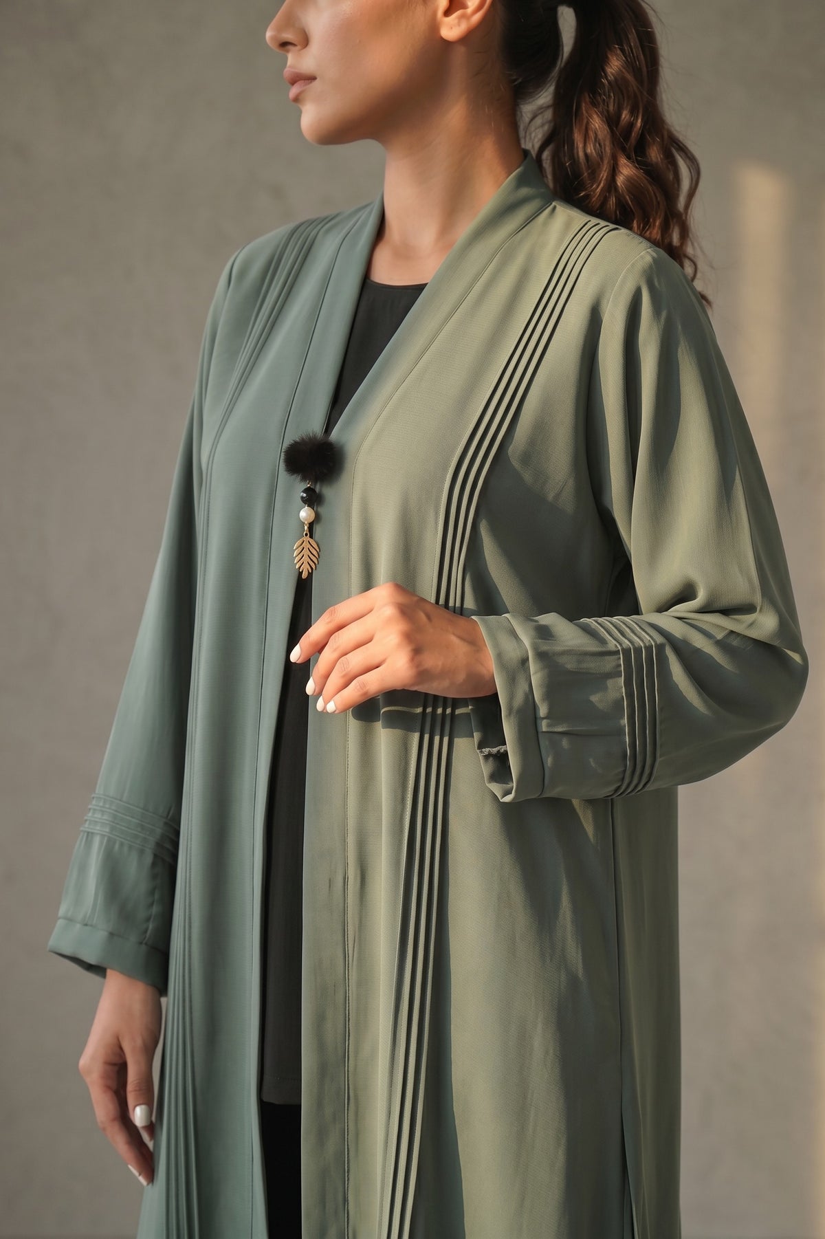 Close-up detail of Sage Green Pleated Buckle Abaya showcasing statement buckle hardware